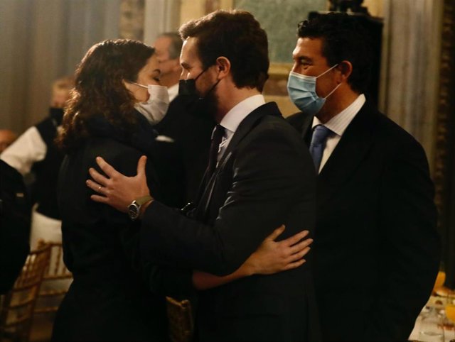 La presidenta de la Comunidad de Madrid, Isabel Díaz Ayuso, se abraza al líder del PP, Pablo Casado, conversan a su llegada al Foro de la Nueva Comunicación, organizado por Nueva Economía Fórum, en el Casino Gran Círculo, a 25 de enero de 2022