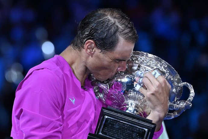FILED - 31 January 2022, Australia, Melbourne: Spanish tennis player Rafael Nadal kisses the Norman Brookes Challenge Cup after winning the men's singles final tennis match of the Australian Open against Russia's Daniil Medvedev. Photo: Dean Lewins/AAP/