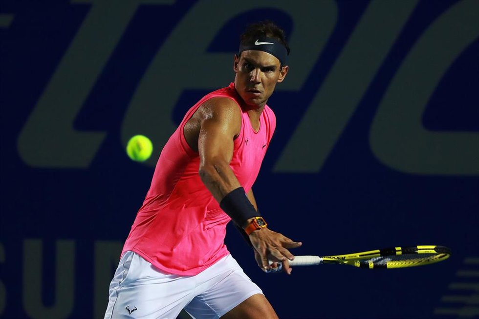 Archivo - Rafa Nadal golpea una bola durante un torneo