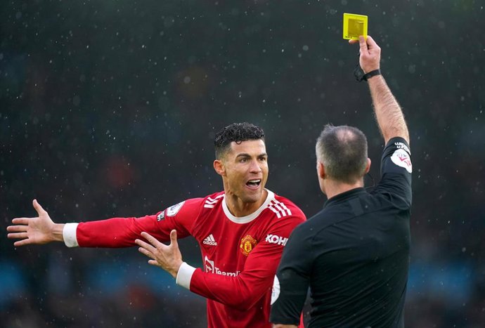 20 February 2022, United Kingdom, Leeds: Manchester United's Cristiano Ronaldo is shown a yellow card by referee Paul Tierney during the English Premier League soccer match between Leeds United and Manchester United at Elland Road. Photo: Mike Egerton/P