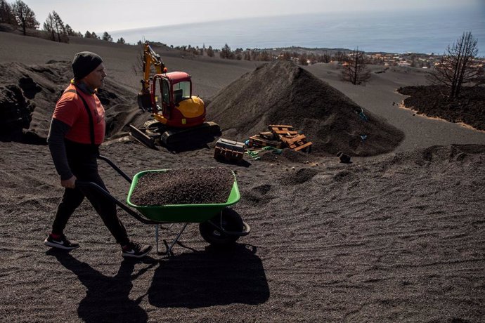 Vicente Leal transporta una carretilla llena de ceniza a 17 de febrero de 2022 en Las Manchas, El Paso, La Palma, Canarias, España. La casa de Vicente Leal, que es su segunda residencia, es la más próxima al cono volcánico del volcán de La Palma y tras 