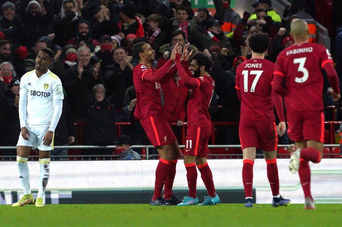 23 February 2022, United Kingdom, Liverpool: Liverpool's Joel Matip (L) celebrates scoring his side's second goal with teammate Mohamed Salah during the English Premier League soccer match between Liverpool and Leeds United at Anfield. Photo: Peter Byrn