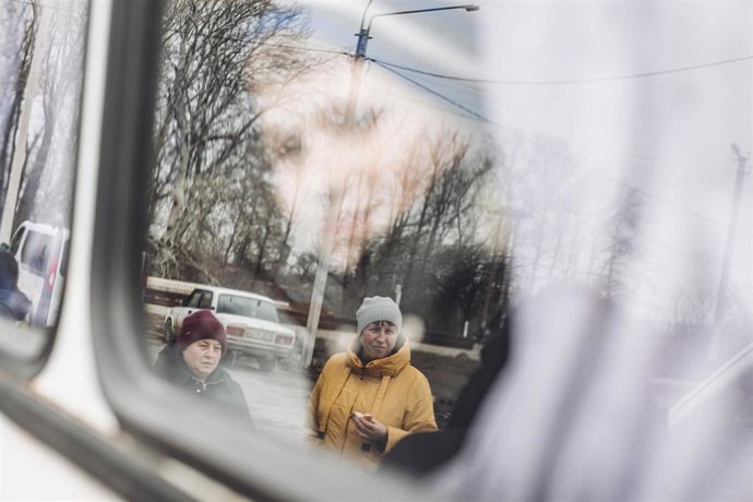 Dos madres observan el autobús donde envían a sus niños al oeste del país, a 24 de febrero de 2022, en Lisichansk, Oblast de Lugansk (Ucrania). L 
