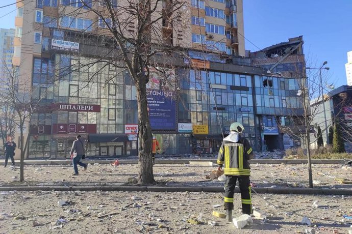 HANDOUT - 26 February 2022, Ukraine, Kiev: A picture provided by the Ukrainian State Emergency Service shows firefighters working in front of a multi-storey residential building in Kiev that was hit by a rocket during the Russian invasion of Ukraine. Ph