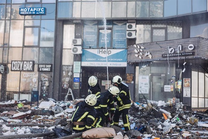 Bomberos intentan apagar un fuego de un edificio civil bombardeado, en una zona residencialen Kiev (Ucrania).   