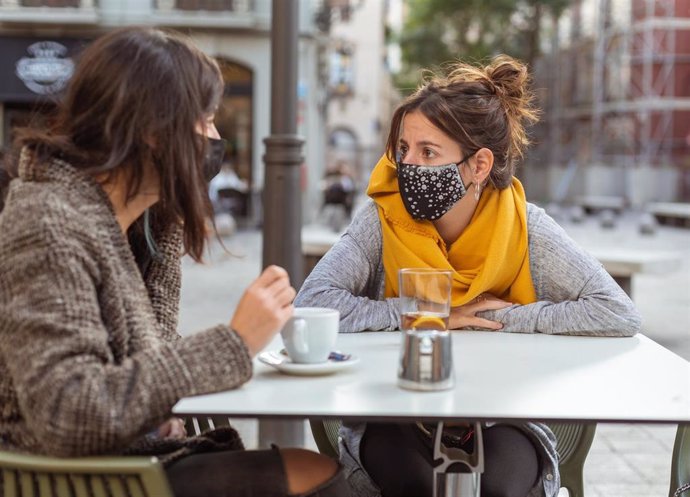 Archivo - Tomando café en la calle con mascarilla.