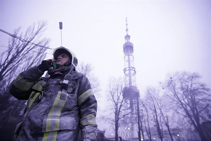 HANDOUT - 01 March 2022, Ukraine, Kiev: Emregency personnel on duty in front of Kiev's TV tower after it came under attack during Russia's assault on the city. (Best possible quality) Photo: -/Ukrainian State Emergency Service/dpa - ATTENTION: editorial