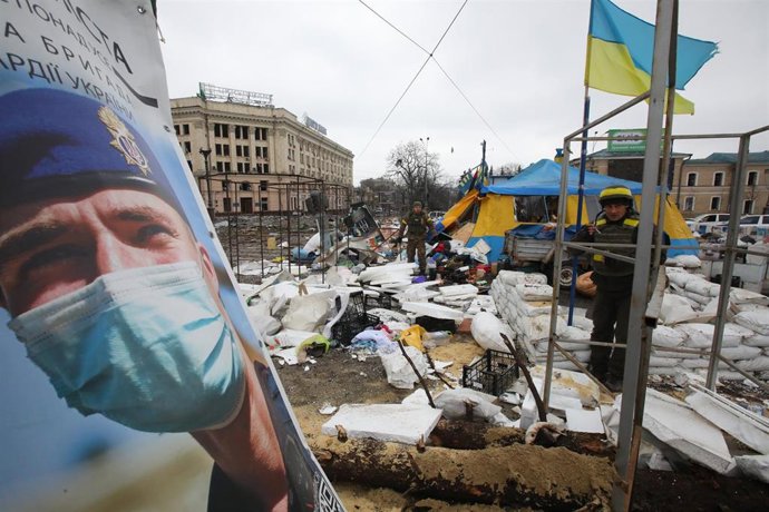 01 March 2022, Ukraine, Kharkiv: A picture of a National Guard officer is placed near the All for Victory Tent of volunteers after a missile launched by Russian troops almost destroyed the Kharkiv Regional State Administration building. Photo: -/Ukrinfo