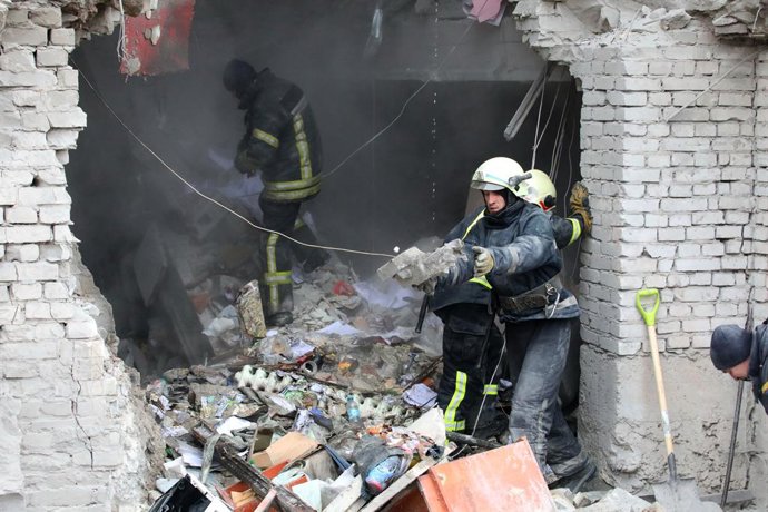 01 March 2022, Ukraine, Kharkiv: Emergency personnel remove debris from inside the building of Kharkiv city hall, which was damaged by a Russian missile attack. Photo: -/Ukrinform/dpa