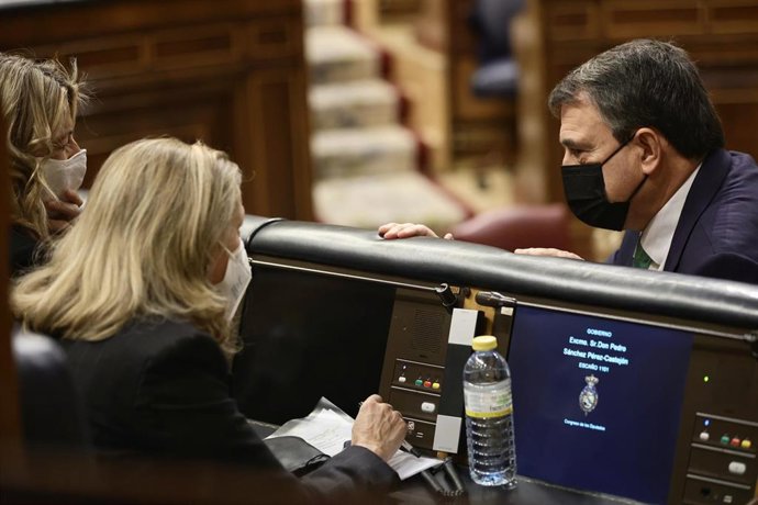El portavoz del PNV en el Congreso, Aitor Esteban, conversa con la vicepresidenta de Trabajo y Economía Social, Yolanda Díaz (i); y la vicepresidenta de Asuntos Económicos, Nadia Calviño, en una sesión plenaria 