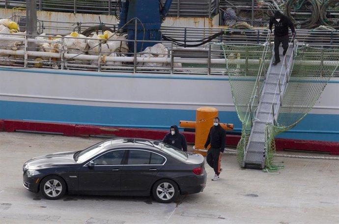 (I-D) El patrón, Juan Padín; su sobrino, Eduardo Rial Padín; y Samuel Kwesi, tripulantes del pesquero gallego que naufragó en aguas canadienses, bajan del pesquero español 'Playa Menduiña Dos' a su llegada al Puerto de San Juan de Terranova, a 19 de feb