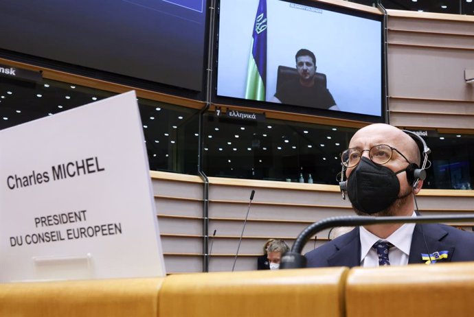 HANDOUT - 01 March 2022, Belgium, Brussels: European Council President Charles Michel listens as Ukrainian President Volodymyr Zelensky addresses members of the European Parliament via video conference during an extraordinary plenary session of the Euro