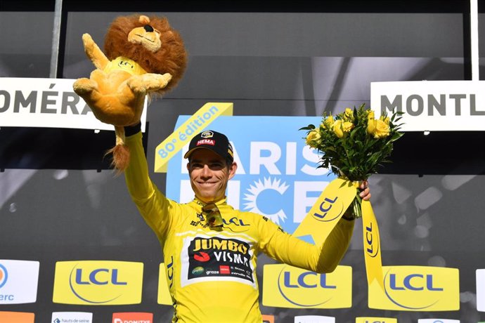 Belgian cyclist Wout Van Aert of Team Jumbo-Visma celebrates on the podium in the yellow leader's jersey after winning the fourth stage of the 80th edition of the Paris-Nice cycling race, a 13.4 km individual time trial from Domerat to Montlucon