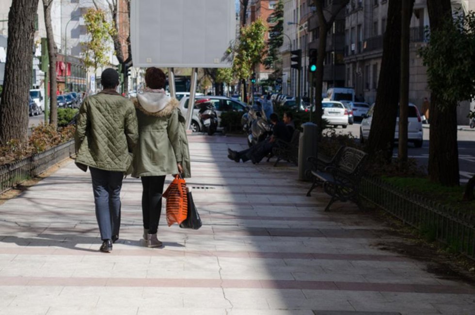 Archivo - Gente paseando por la calle tras hacer unas compras