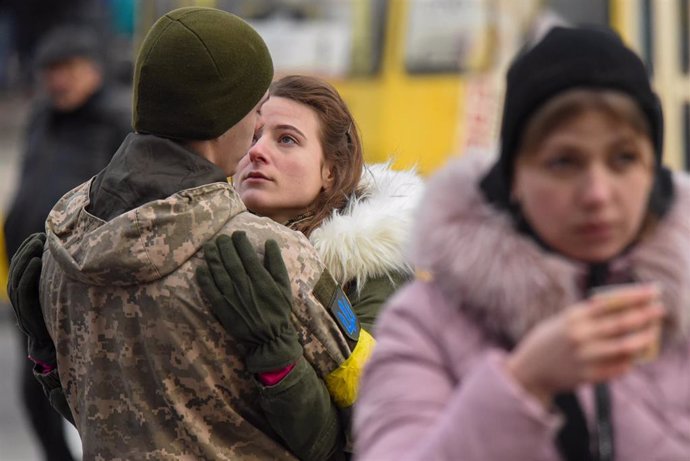 09 March 2022, Ukraine, Lviv: Olga says goodbye to her boyfriend Volodimir as soldiers heading east to the front lines in the war with Russia at a train station in Lviv.