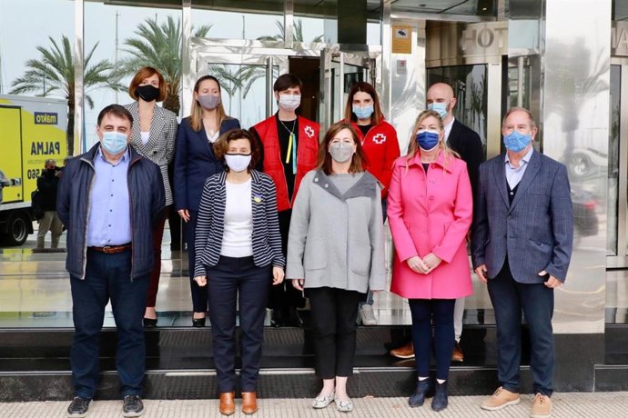 La presidenta del Govern, Francina Armengol, la consellera de Salud y Consumo, Patricia Gómez, la consellera de Asuntos Sociales y Deportes, Fina Santiago, y los responsables del dispositivo habilitado por la Cruz Roja, durante su visita al hotel Bellve