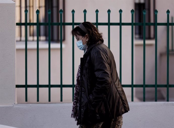 Archivo - Una mujer camina con mascarilla, a 8 de febrero de 2022, en Madrid (España). El Gobierno aprueba hoy en Consejo de Ministros la obligatoriedad del uso de las mascarillas en exteriores, medida que entrará en vigor el próximo 10 de febrero. Desd