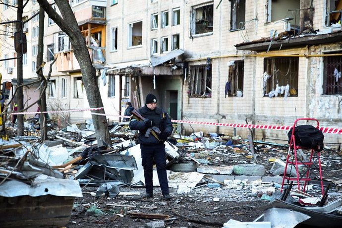 March 14, 2022, Kyiv, Ukraine: A Ukrainian police officer stands guard outside a destroyed residential building in the Oblon District of Kyiv. A piece of falling missile, shot down by the air raid defense system, struck a residential building in Kyiv st