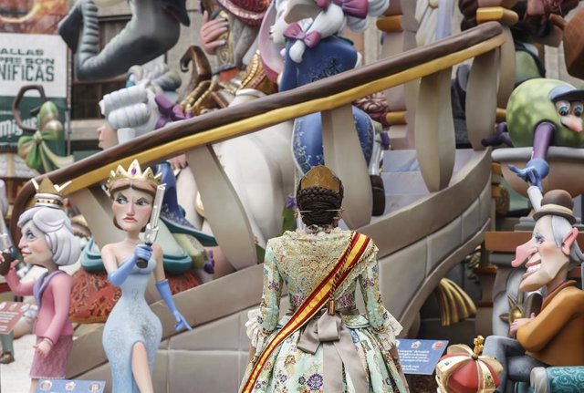 Una fallera observa la falla Antic Regne de València tras la 'plantá'. 