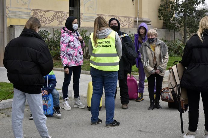 Refugiats parlen amb una traductora en arribar al centre habilitat a Barcelona