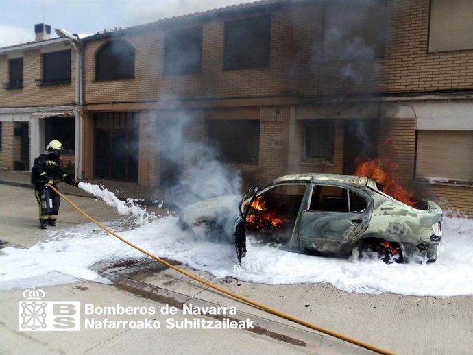 Un bombero extingue las llamas de un vehículo incendiado en Andosilla