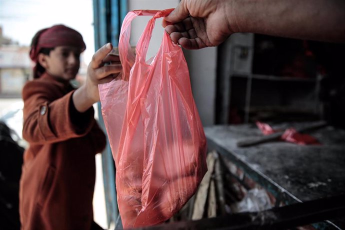 Un niño compra pan en una panadería de Sanaa. Yemen,