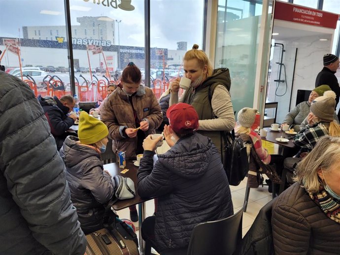 Familias ucranianas desayunan en una cafetería a su llegada a Valencia