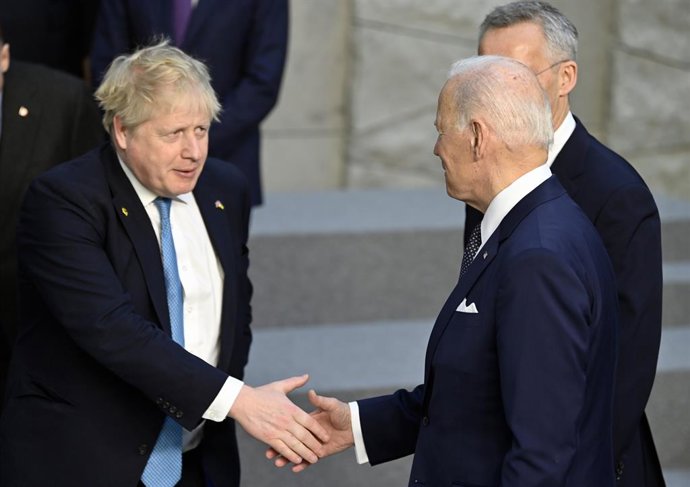 24 March 2022, Belgium, Brussels: UK Prime Minister Boris Johnson (L) greets US President Joe Biden during a family photo at the NATO headquarters before the start of a special meeting of NATO Leaders to discuss Russia's invasion of Ukraine. Photo: Eric