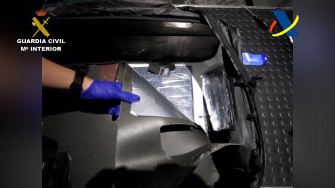 Agentes de la Guardia Civil inspeccionan una maleta en el aeropuerto de Bilbao, donde han localizado 1.880 gramos de cocaína.