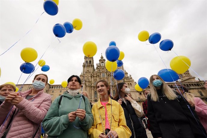 Varias personas lanzan globos al aire como gesto para el fin de la guerra en Ucrania, en la plaza del Obradoiro, a 25 de marzo de 2022, en Santiago de Compostela