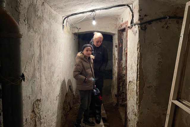 March 15, 2022, Lviv, Ukraine: A Ukrainian mother and her son remain inside a bomb shelter in Lviv, following the air raid siren started at around 6:17 PM local time, as Russian invasion of Ukraine continues