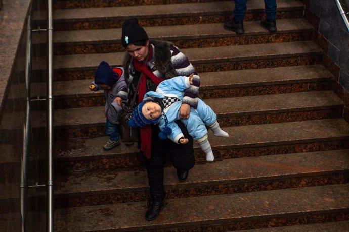 March 24, 2022, Lviv, Lviv Oblast, Ukraine: A mother holds her children after arriving in Lviv from Mariupol. A train carrying refugees from war torn Mariupol arrived at the Lviv train station. Many will continue their journey from Lviv out of Ukraine.,