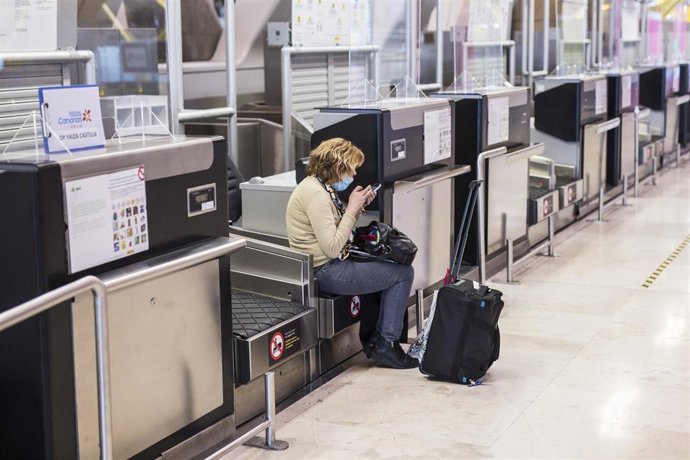 Archivo - Una mujer con una maleta en la terminal T4 del Aeropuerto Adolfo Suárez Madrid-Barajas.-