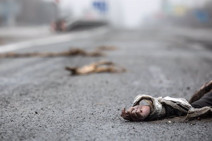02 April 2022, Ukraine, Bucha: A dead civilian is seen on a road in Bucha, 20 km outside the capital Kiev. Nearly 300 civilians were killed along the road in Bucha. Most of the victims were trying to cross the Buchanka River to enter Ukrainian-controlle