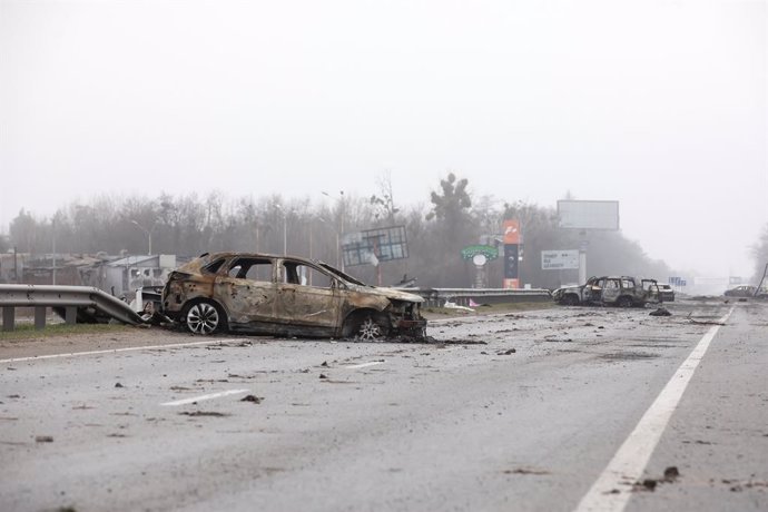 02 April 2022, Ukraine, Bucha: A destroyed car is seen on a rural road near Bucha, 20 km outside the capital Kiev. Nearly 300 civilians were killed along the road in Bucha. Most of the victims were trying to cross the Buchanka River to enter Ukrainian-c