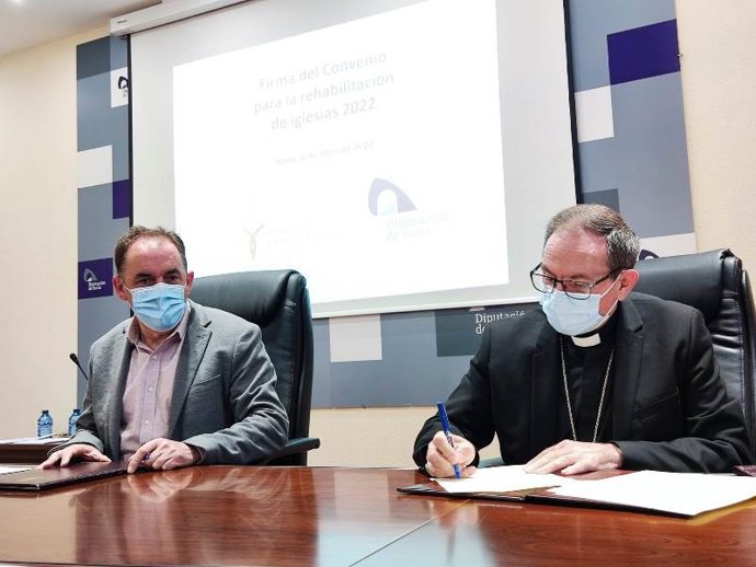 Benito Serrano (izda) y Abilio Martínez firman el convenio para la rehabilitación de templos sorianos.