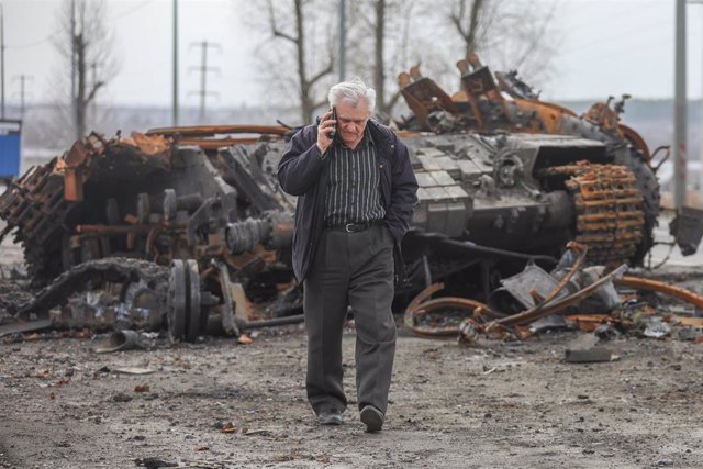 Un hombre hablando por teléfono junto a un tanque en Kharkov