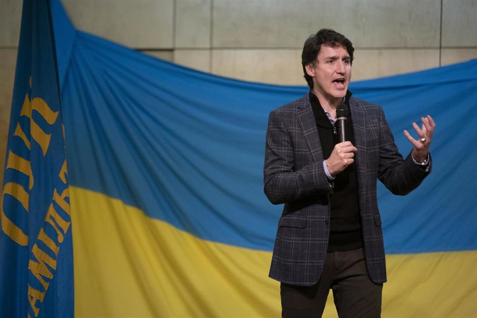 El primer ministro de Canadá, Justin Trudeau, delante de una bandera de Ucrania.