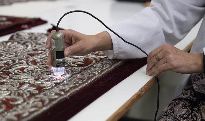 Una técnico escanea una de las piezas del palio de la Virgen del Valle de Sevilla.