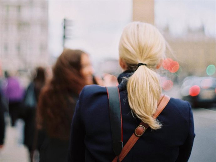 Two women in London on the street near Big Ben, The Elizabeth Tower in Westminster, in London.