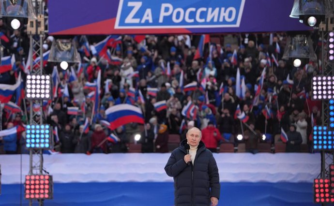 HANDOUT - 18 March 2022, Russia, Moscow: Russian President Vladimir Putin delivers a speech during a concert held to mark the eighth anniversary of Russia's annexation of Crimea at the Luzhniki stadium. Photo: -/Kremlin/dpa - ATTENTION: editorial use on