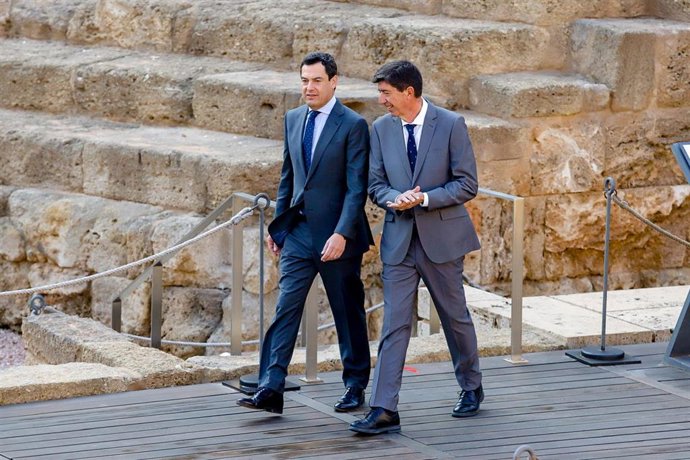 El Presidente de la Junta de Andalucía, Juanma Moreno (i), y el vicepresidente de la Junta, Juan Marín(d), camina juntos para posan en la fotografía conmemorativa ante el Teatro Romano, con motivo de la reunión que celebra el Consejo de Gobierno en Mála
