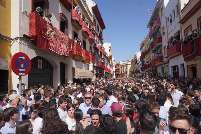 Una multitud de personas en la calle Pureza par ver la cofradía de Hermandad de la Esperanza de Triana, en la Semana Santa en Sevilla 2022. La Madrugá a 15 de marzo del 2022 en Sevilla (Andalucía, España)