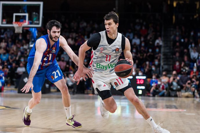 Vladmir Lucic of FC Bayern Munich  in action against Alex Abrines of FC Barcelona during the Turkish Airlines EuroLeague Play Off Game 1 match between FC Barcelona and FC Bayern Munich  at Palau Blaugrana on April 19, 2022 in Barcelona, Spain.