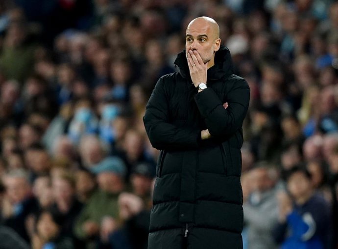 20 April 2022, United Kingdom, Manchester: Manchester City manager Pep Guardiola stands on the sideline during the English Premier League soccer match between Manchester City and Brighton & Hove Albion at the Etihad Stadium. Photo: Martin Rickett/PA Wir