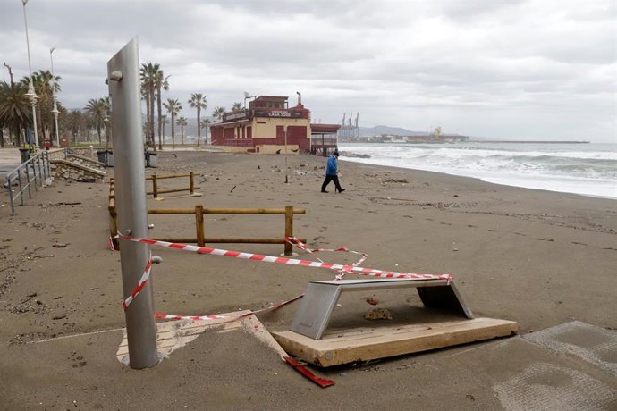 Una persona pasea por la playa de Huelín donde los desperfectos causados por el temporal en una imagen de archivo 