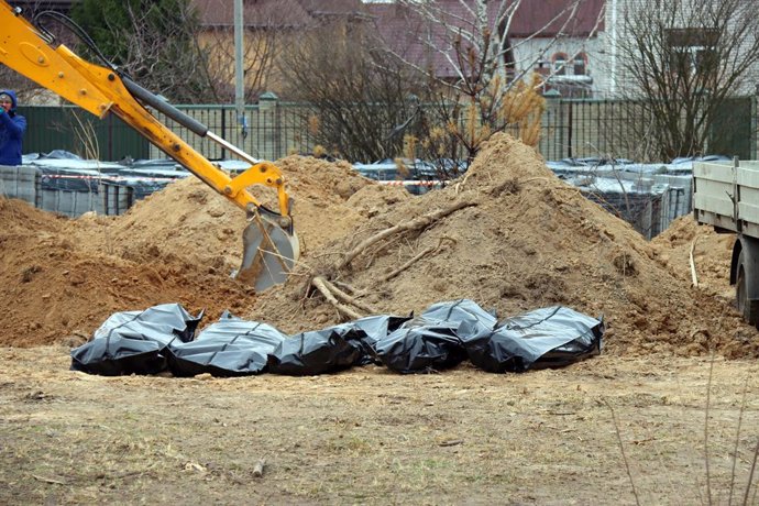 April 13, 2022, Bucha, Kyiv Region, Ukraine: Human remains pouches are arranged on the ground during the exhumation of dead bodies from another mass grave where civilians killed by Russian invaders are buried, Bucha, Kyiv Region, northern Ukraine.,Image