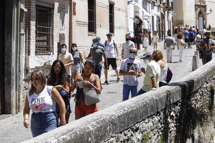 Archivo - Turistas con y sin  mascarillas por las calles de Granada (archivo)
