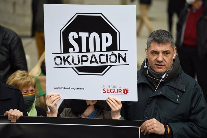 Archivo - Una persona, con una pancarta que rezan 'Stop Okupación' en la concentración en apoyo a los afectados por la okupación, a 27 de marzo de 2022, en Madrid (España).