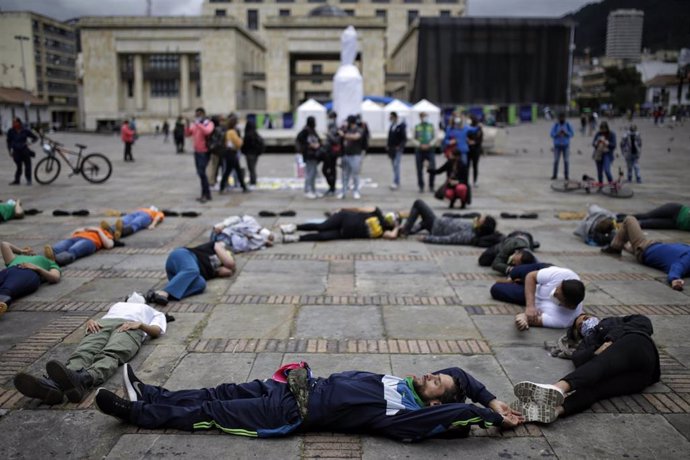 Archivo - 30 August 2021, Colombia, Bogota: People lie on the ground during a protest demanding an investigation into the killing of civilians during the country's armed conflict on International Day of the Disappeared. Photo: Sergio Acero/colprensa/dpa